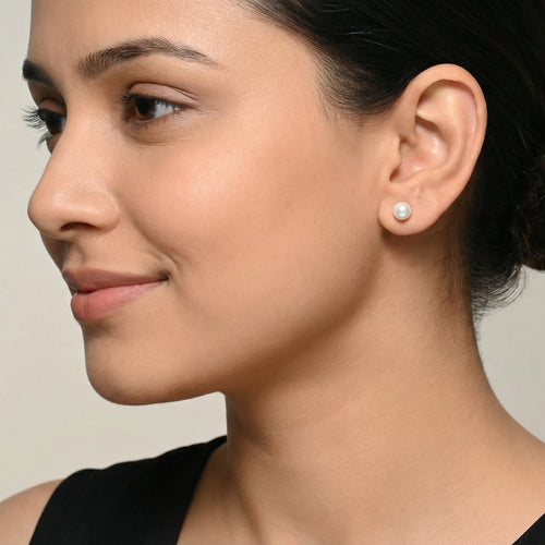 Closeup of a woman wearing a fresh water pearl silver stud earring