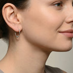 Close-up of a woman wearing an accent bead Bali silver hoop earring
