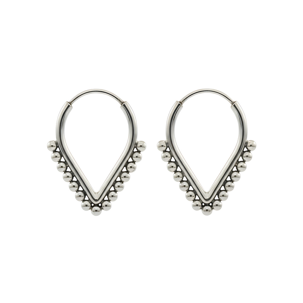 Pair of v-shaped silver hoop earrings with bead detailing on a white background