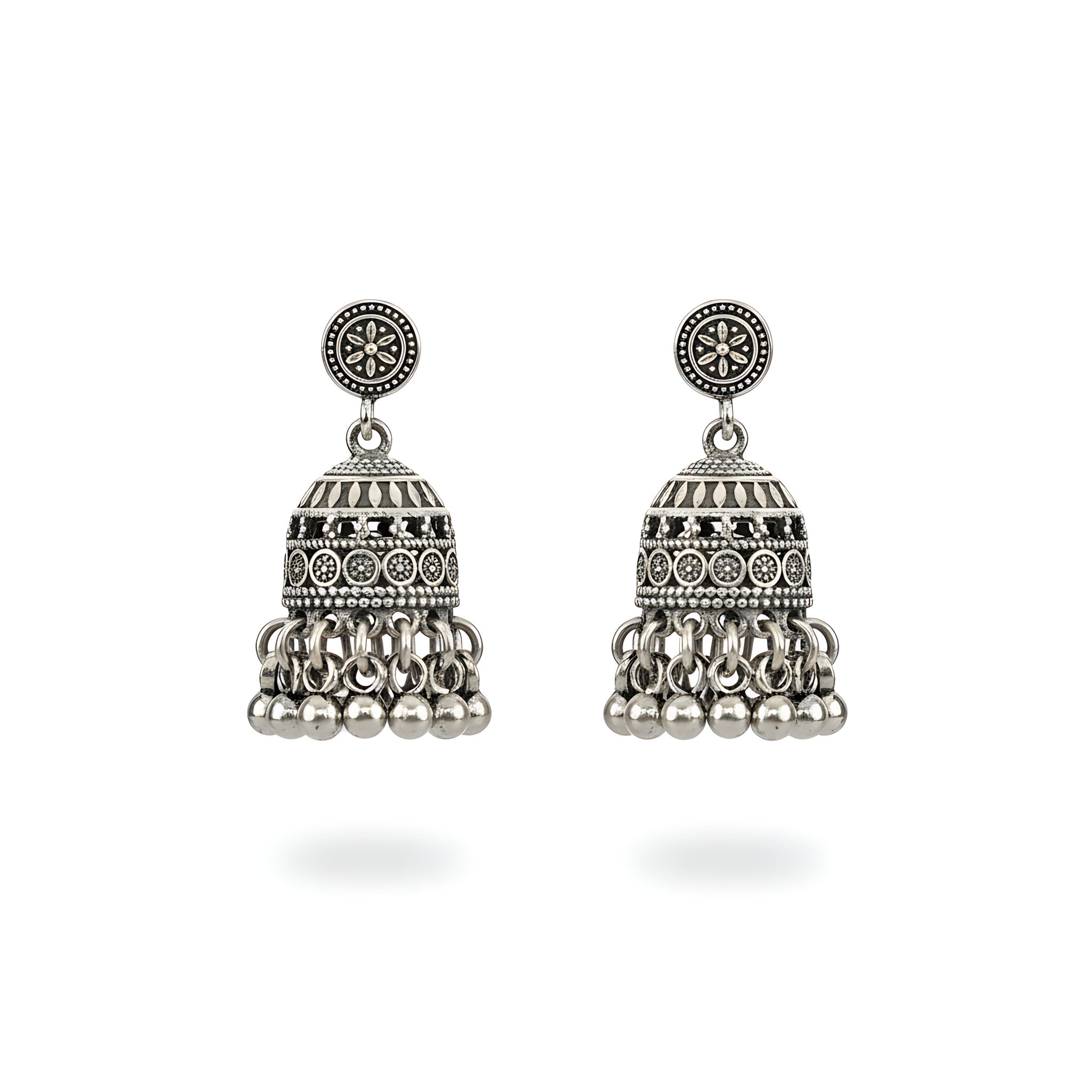 Pair of small oxidized silver jhumka earrings on a white background
