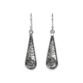 Pair of hammered oxidized silver teardrop earrings with spiral designs on a white background