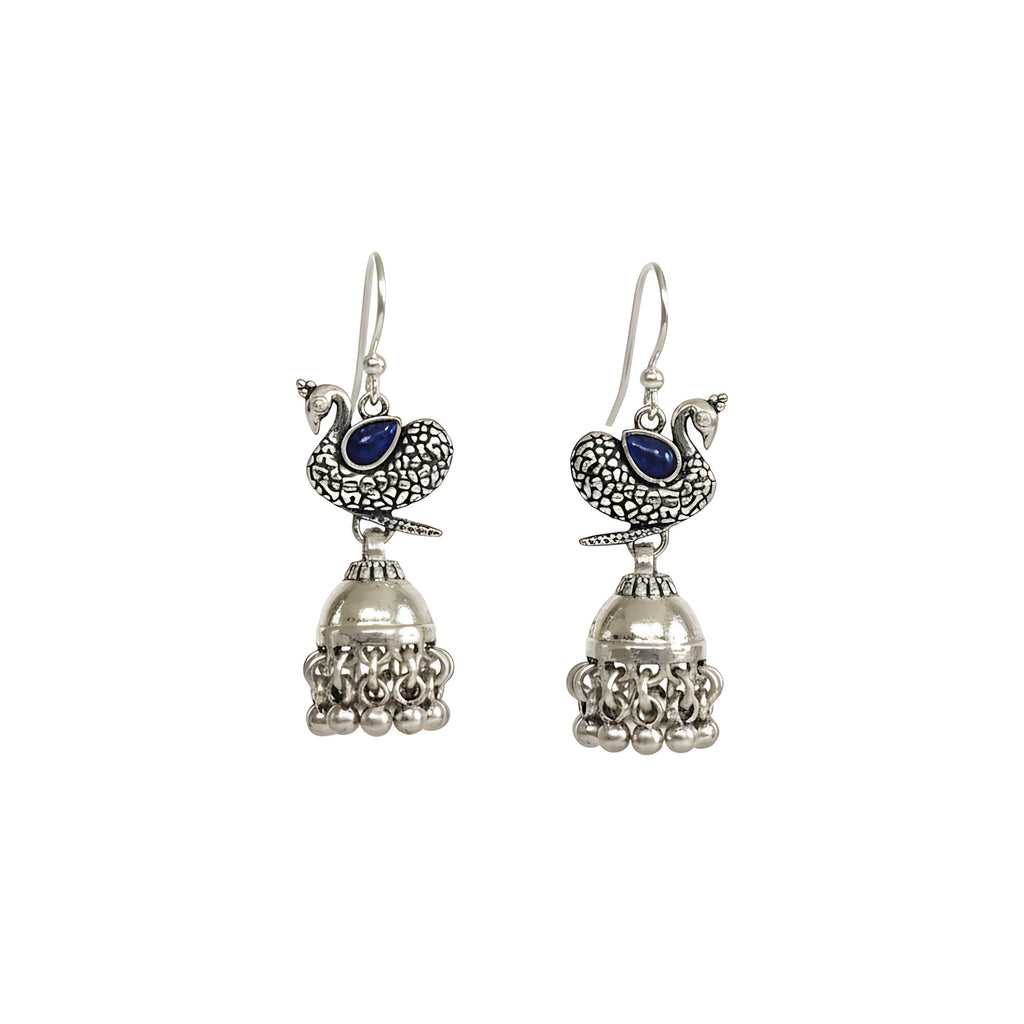 Pair of silver peacock jhumka earrings with blue stones on a white background