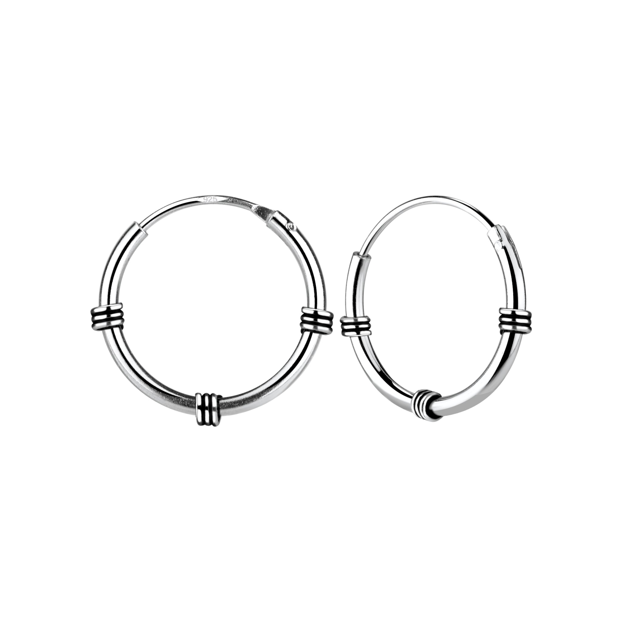 Pair of oxidized silver triple band Bali hoop earrings on a white background