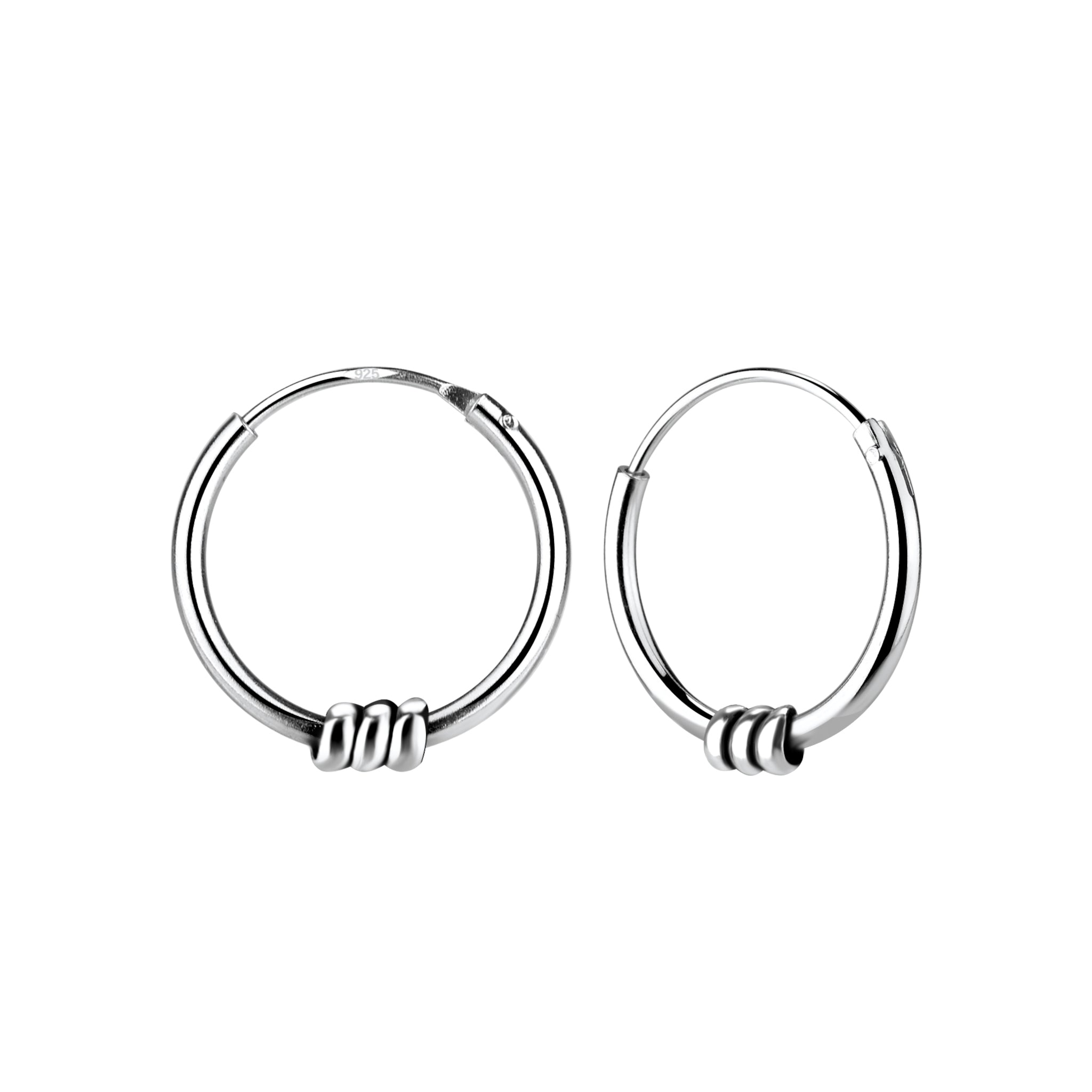 Pair of triple band Bali silver hoop earrings on a white background