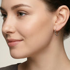 Close-up of a woman wearing a twisted rope Bali silver hoop earring