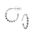 Pair of silver Bali half hoop stud earrings on a white background
