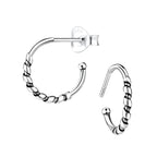 Pair of silver Bali half hoop stud earrings on a white background