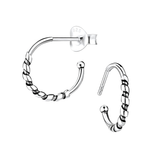 Pair of silver Bali half hoop stud earrings on a white background