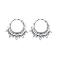 Pair of Bali silver hoop earrings with decorative elements on a white background