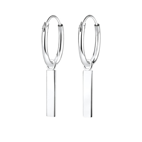 Silver hoop earrings with bar charms on a white background