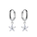 Silver hoop earrings with star-shaped charm with CZ stones on a white background
