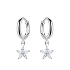 Silver hoop earrings with star-shaped charm with CZ stones on a white background