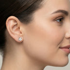 Closeup of a woman wearing a CZ flower stud earring