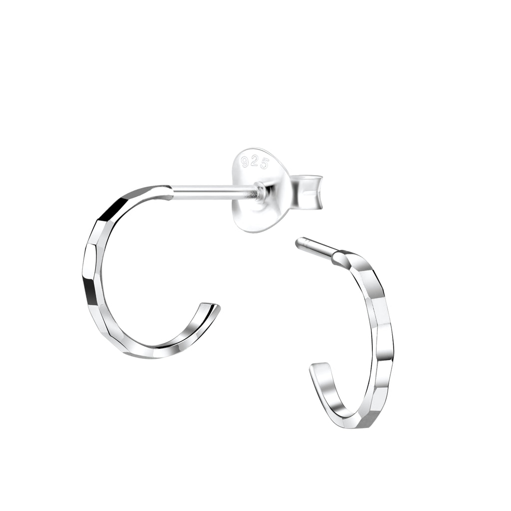 Silver diamond cut half hoop stud earrings on a white background