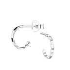 Silver diamond cut half hoop stud earrings on a white background