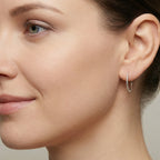 Closeup of a woman wearing diamond cut hoop earring