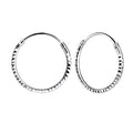 Pair of diamond cut silver hoop earrings on a white background