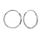 Pair of diamond cut silver hoop earrings on a white background