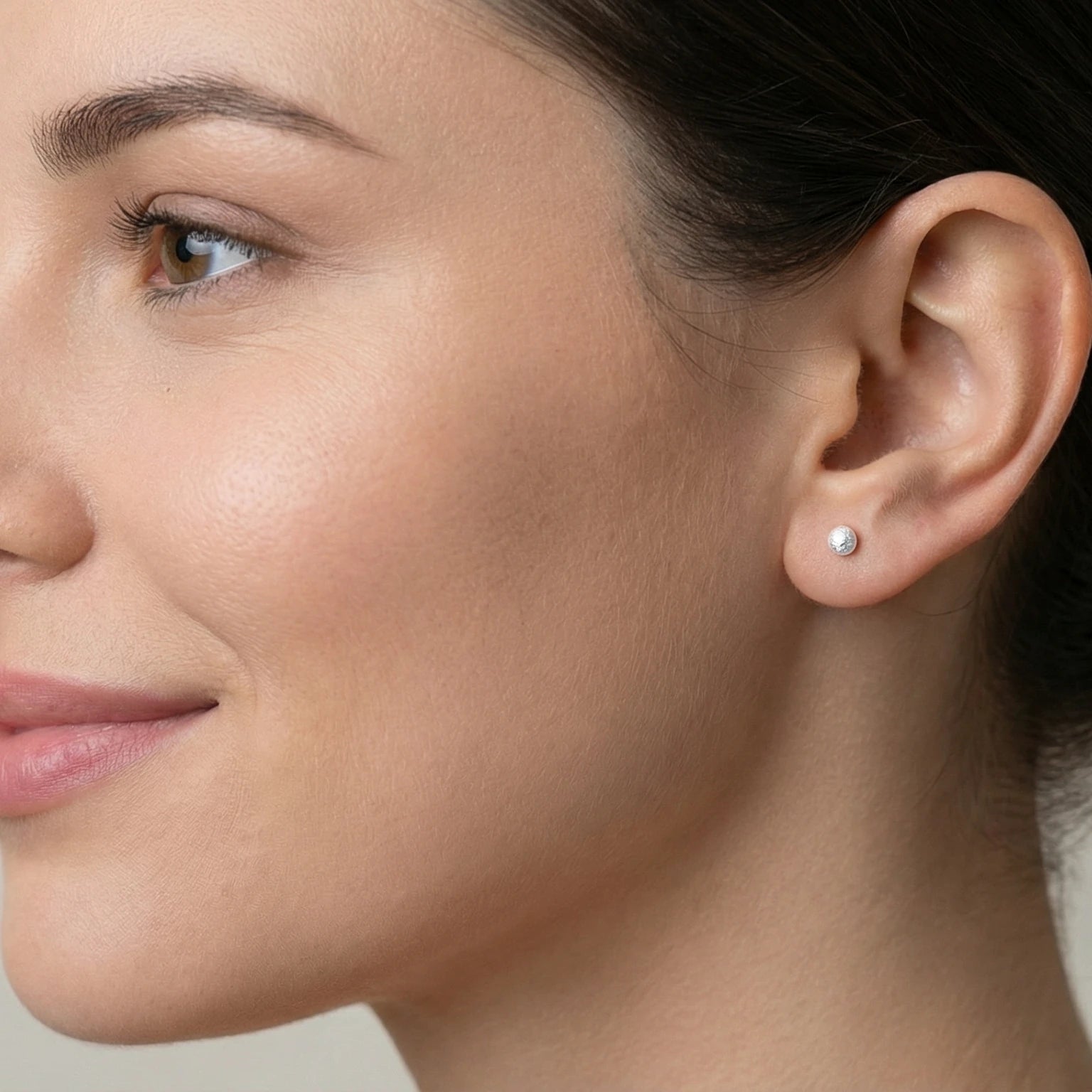 Close-up of a female wearing a diamond dusted ball stud earring