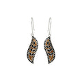 Pair of enamel silver earrings with black and brown design on a white background
