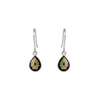 Dewdrop-shaped silver enamel earrings with black and yellow floral designs on a white background