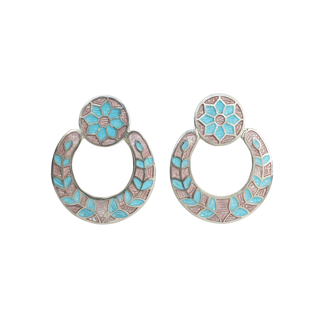 Pair of silver enamel earrings with floral design on a white background