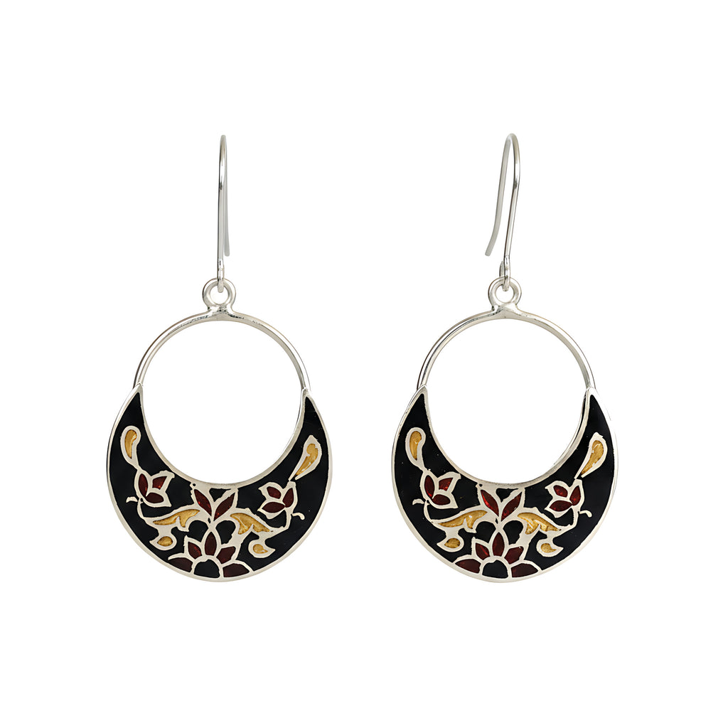 Pair of silver enamel earrings with black and gold floral patterns on a white background