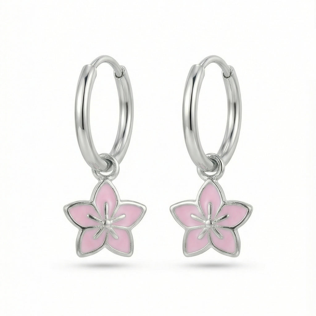 Silver hoop earrings with lavender flower charms on a white background