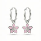 Silver hoop earrings with lavender flower charms on a white background