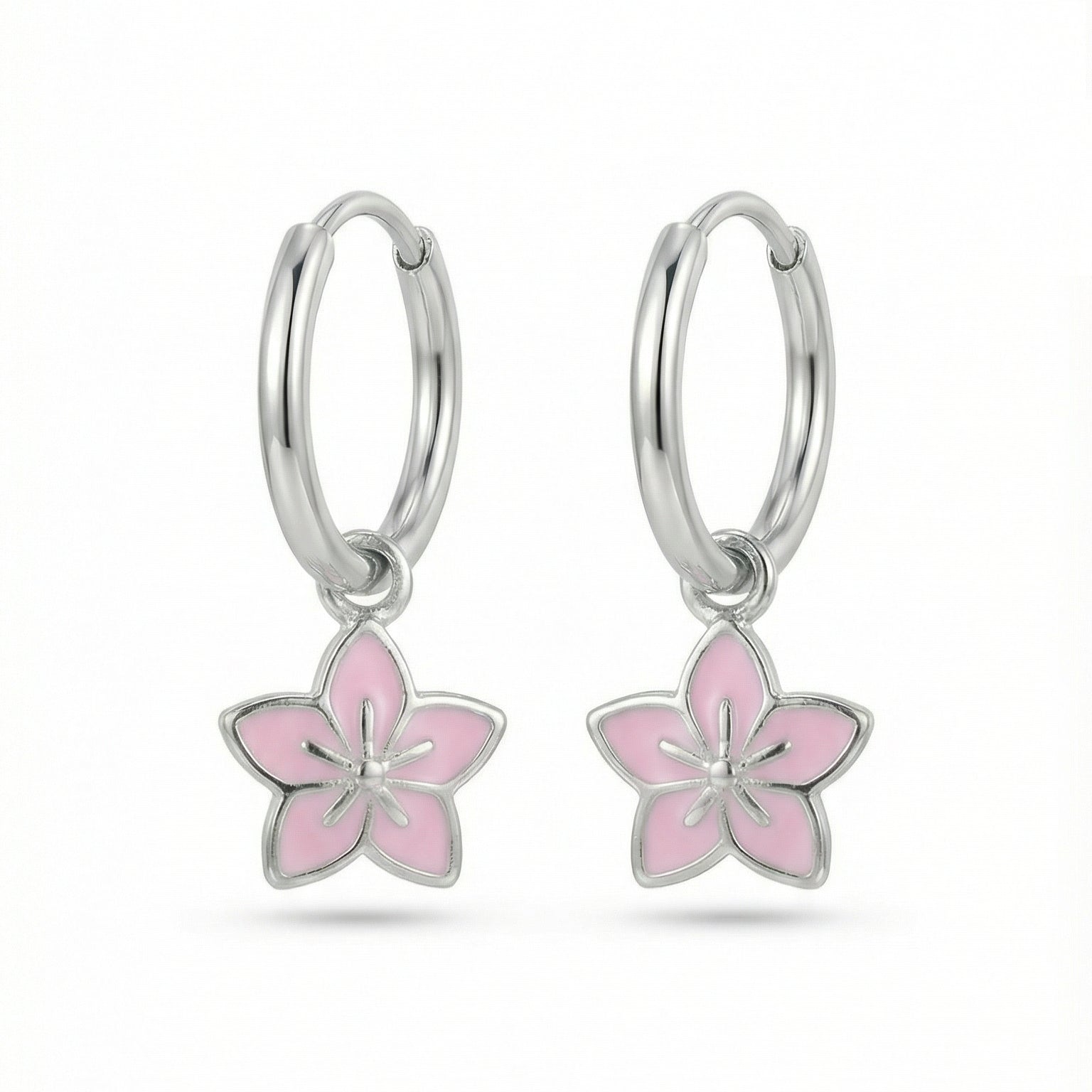 Silver hoop earrings with lavender flower charms on a white background