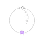 Silver bracelet with a purple flower charm on a white background