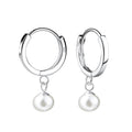 Silver hoop earrings with fresh water pearl drops on a white background