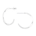 Silver hammered half hoop stud earrings on a white background
