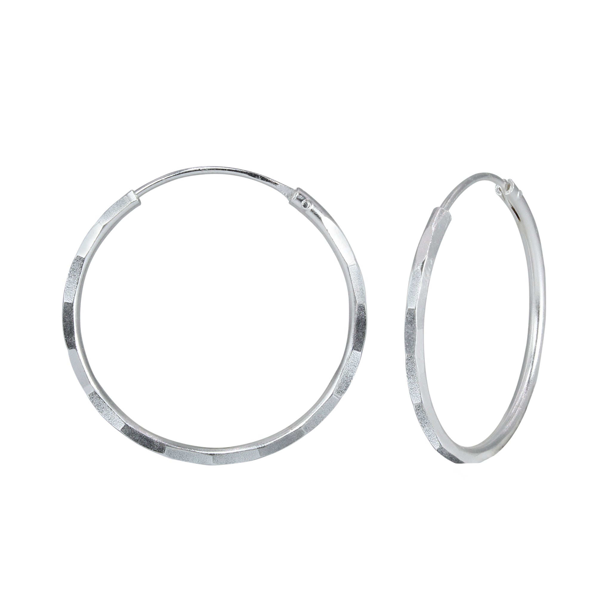 Pair of hammered silver hoop earrings on a white background