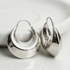 Pair of silver hoop earrings on a white background
