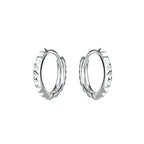 Pair of silver hoop earrings with spiked design on a white background