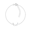 Silver bracelet with a crescent moon charm on a white background