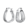 Pair of silver patterned geometric French lock hoop earrings on a white background