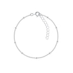Silver satellite bracelet with small beads on a white background