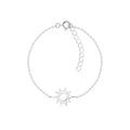 Silver bracelet with a sun-shaped charm on a white background