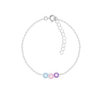 Silver bracelet with triple daisy flower-shaped charms on a white background